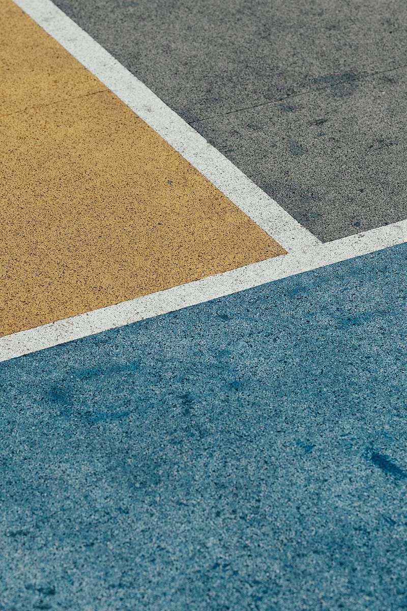 hong kong closeup gray, yellow, and blue painted pavement minimal